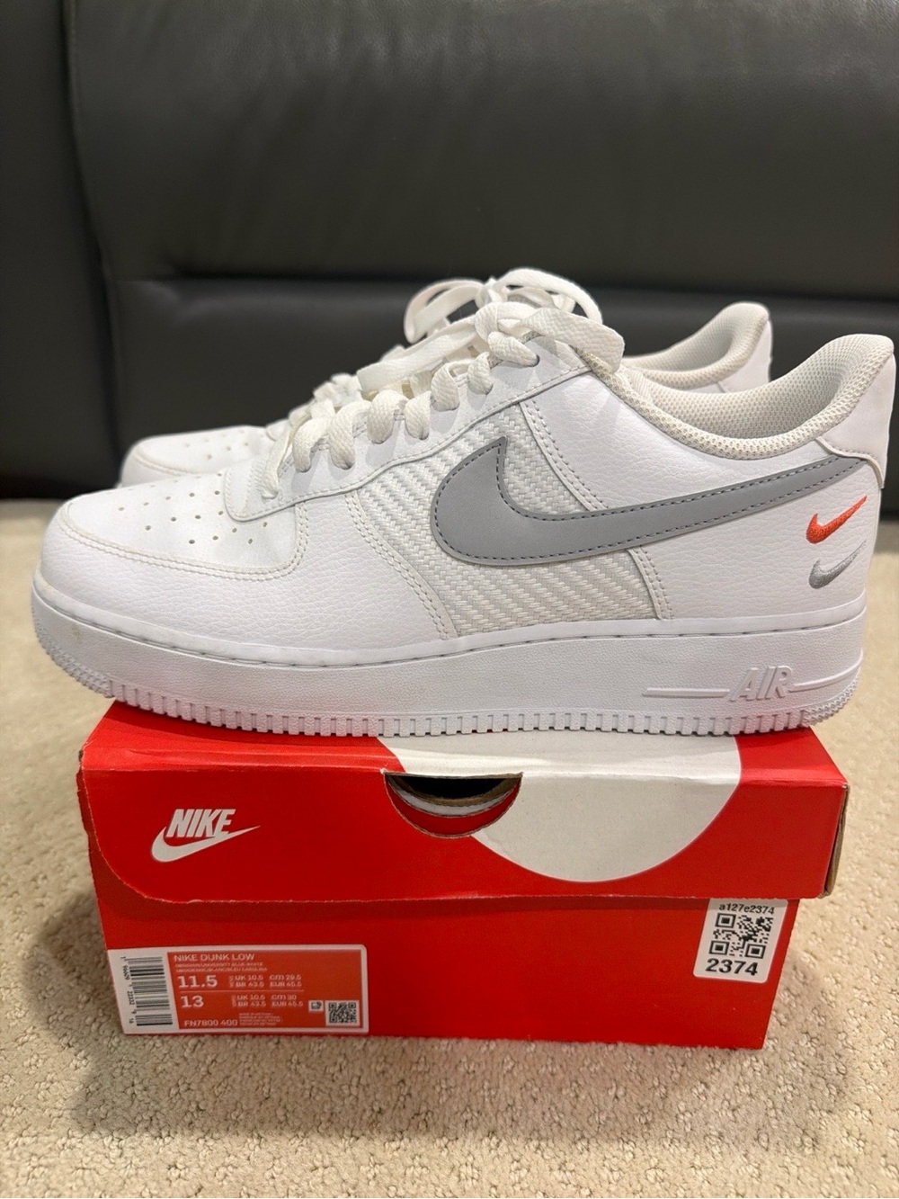 Nike Men's White Low-Top Sneakers with Gray Swoosh and Orange Accent